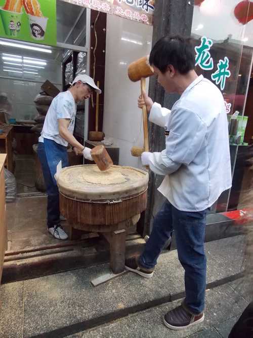 Workers smashing some sort of grains? Workers smashing grains