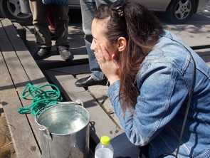 Brittany washing her face with the well water Brittany washing face with water